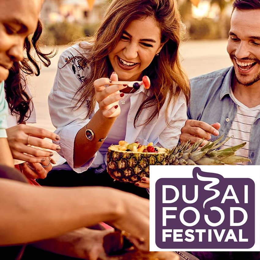 Guests enjoying a lively food festival in Dubai, featuring a diverse array of international cuisines, vibrant decorations